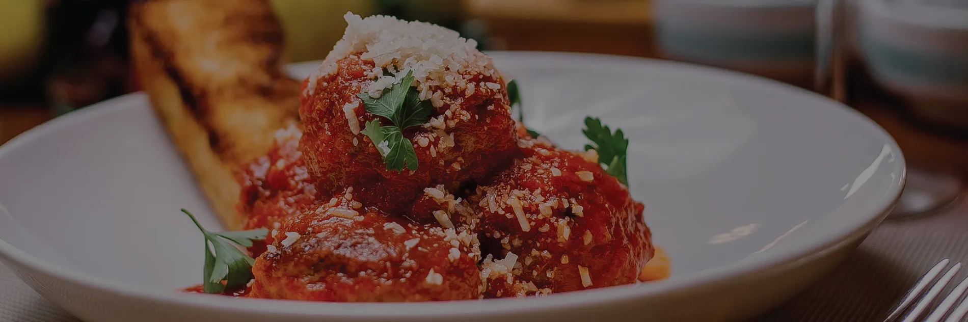 Homemade meatballs in red sauce at Di Papa's